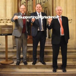 George Freeman MP, Charlie Dewhirst MP and Daniel Zeichner MP hold a #SupportingAgriscience banner in the Houses of Parliament