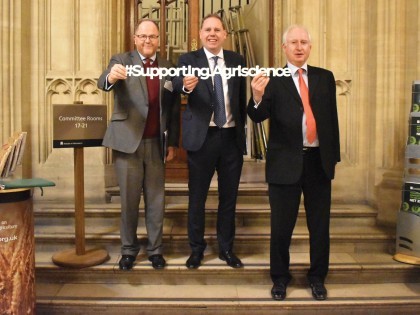 George Freeman MP, Charlie Dewhirst MP and Daniel Zeichner MP hold a #SupportingAgriscience banner in the Houses of Parliament